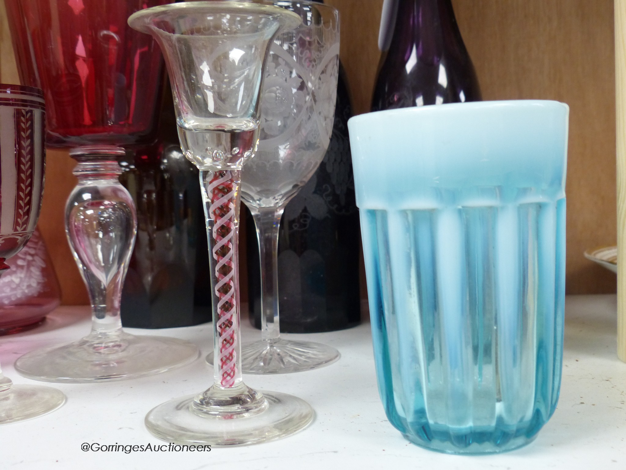 A pair of amethyst glass decanters, cranberry glass and mixed 19th and 20th century coloured glassware